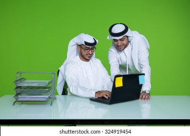 Emirati businessmen using laptop