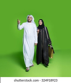 Emirati couple carrying shopping bags