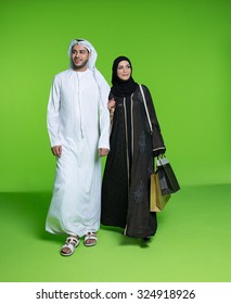 Emirati Couple Carrying Shopping Bags