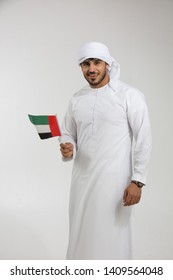 Emirati Man Holding The UAE National Flag.