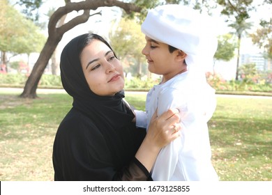 Emirati Mother During Day Time With Son. Arab Woman With Family. Middle East Emarat Mom With Arabic Child On Abaya And Kandora