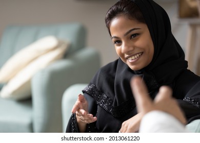 An emirati woman having a pleasant conversation with another person