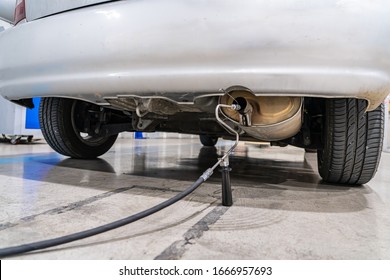 Emission control with a gas sensor in the exhaust of an old car at a vehicle inspection station