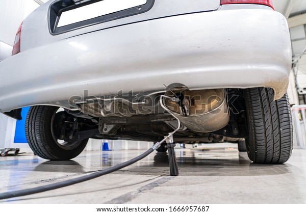 Emission control with a gas sensor in\
the exhaust of an old car at a vehicle inspection\
station