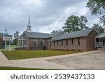 Emmet First Baptist Church with a spire and a cross on top in Nevada County, Arkansas, USA