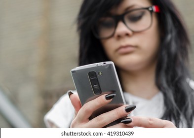 Emo Girl Reads Message On Mobile Phone