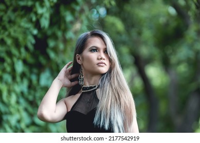 An Emo And Goth Asian Lady With Blonde Dyed Hair In A Black Dress. Outdoor Shoot.