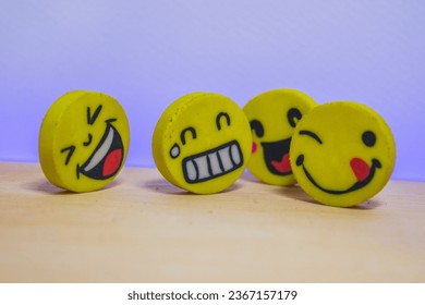 Emojis with different emotions on a wooden table. - Shutterstock ID 2367157179
