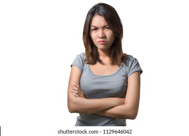 Emotion Concept, Portrait Of Angry Cute Asian Woman Standing Posing With Crossed Arms Looking At Camera With Grey Clothes On A White Background, With Clipping Path.