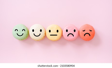 Emotion Face On Multi Colored Macarons ,good Feedback Rating And Positive Customer Review, Experience, Satisfaction Survey ,mental Health Assessment, Child Wellness, World Mental Health Concept