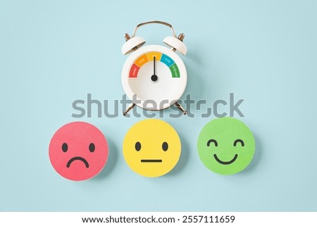 emotion face on stack of real color paper cut with indicator half circle on white clock dial for evaluation, customer feedback, rating, performance and service, mental health concept