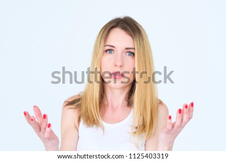 emotion face. puzzled perplexed shocked surprised woman. hands at loss. young beautiful blond girl portrait on white background.