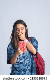 Emotion: Latin Girl Looking At Her Phone And Expressing Surprise At The Promotions She Found. Surprised Young Student Watching Content On Her Phone