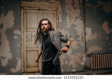 Emotion male portrait of man with dreadlocks in theater studio.