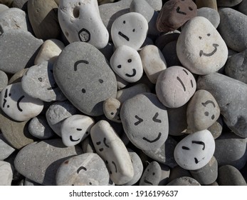 Emotion management concept, stones with painted faces symbolize different emotions. We are all different, but all together, learning to manage emotions