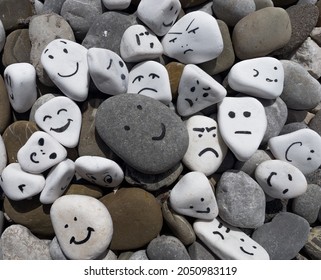 Emotion management concept, stones with painted faces symbolize different emotions. We are all different, but all together, learning to manage emotions - Shutterstock ID 2050983119