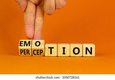 Emotion and perception symbol. Businessman turns wooden cubes and changes the word 'perception' to 'emotion'. Beautiful orange background. Business, emotion and perception concept. Copy space.