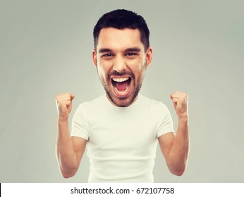 Emotion, Success, Gesture And People Concept - Young Man Celebrating Victory And Screaming Over Gray Background  (funny Cartoon Style Character With Big Head)