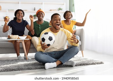 Emotional African American Friends Watching Football Game At Home