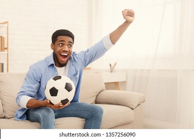 Emotional African American Soccer Fan Watching Sports On Tv And Supporting Team At Home, Copy Space