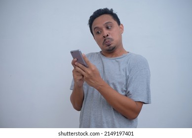 Emotional Asian Guy Looking Phone Screen