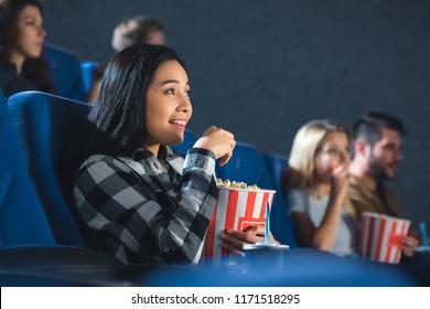 Emotional Asian Woman With Popcorn Watching Movie In Cinema