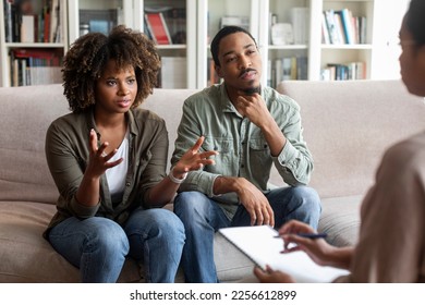 Emotional beautiful young black lady complaining about her husband at therapy session, unhappy married african american couple experiencing difficulties in relationships, visiting family counselor - Powered by Shutterstock