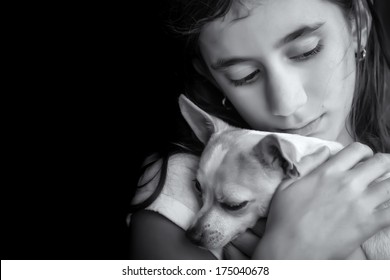 Emotional Black And White Portrait Of A Sad Lonely Girl Hugging Her Small Dog