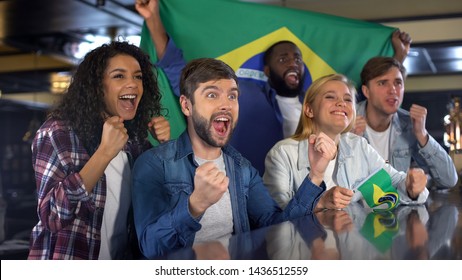 Emotional Brazilian football fans with flags celebrating national team victory - Powered by Shutterstock