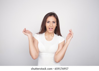 emotional brunette girl with long hair posing at Studio. white background. problematic skin and large eyes. dressed in jeans and a light shirt. Wallpapers for desktop, catalogue and stock - Shutterstock ID 659176957