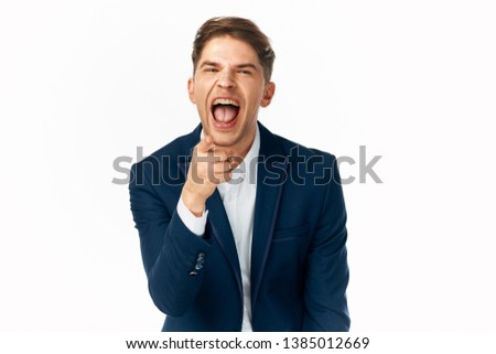 Emotional business man in suit blue background 