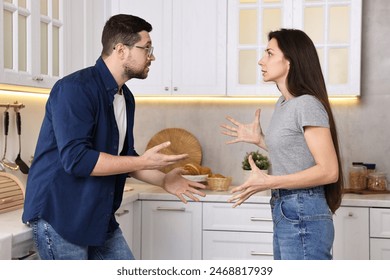 Emotional couple arguing in kitchen. Relationship problems - Powered by Shutterstock