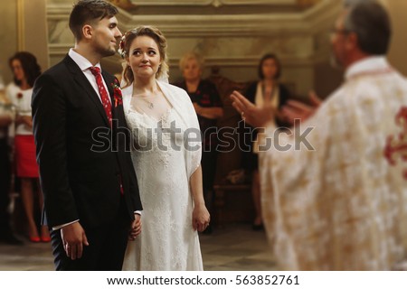 emotional couple during wedding ceremony 450w 563852761