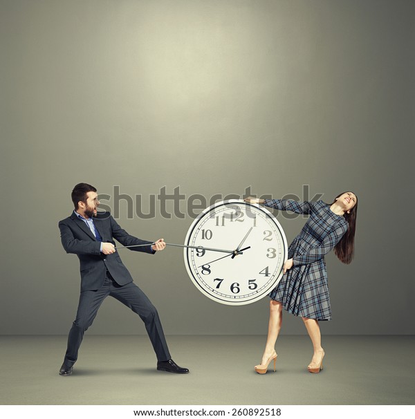 emotional couple stretching out the clock and\
screaming over dark\
background