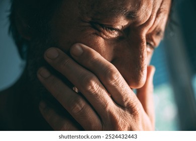 Emotional distraught sad man crying stressed, dealing with mental health problems, depression, anxiety and despair, selective focus - Powered by Shutterstock