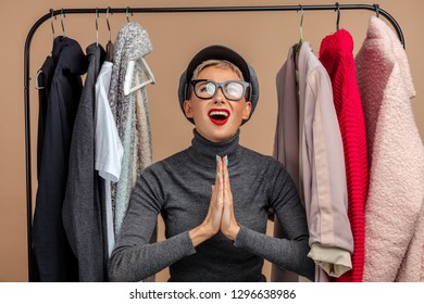 Emotional Fashion Girl Asking The God Favourite Clothes. Request. Plea.isoltaed Pink Background. Studio Shot