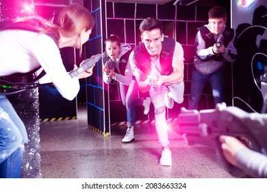 Emotional Guy With Laser Pistol Playing Laser Tag With Friends On Lasertag Gaming Arena