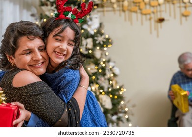 Emotional hug between a granddaughter and her grandmother during the Christmas holidays. - Powered by Shutterstock