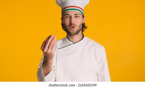 Emotional Italian Chef Showing Delicious Gesture Wearing Uniform Isolated. Attractive Man In Chef Hat Posing Over Colorful Background