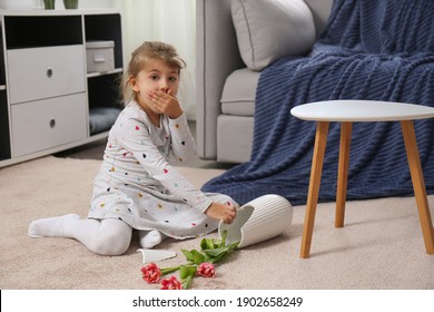 Emotional Little Girl And Broken Ceramic Vase On Floor At Home