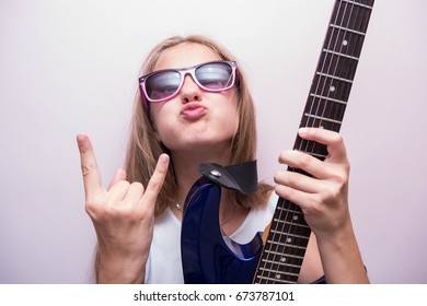 Emotional little girl with guitar in studio