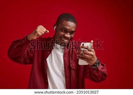 emotional man african appearance with phone in hands technology communication joy