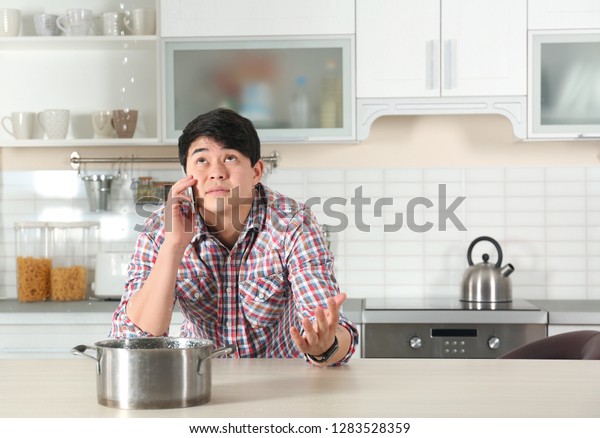 Emotional Man Calling Plumber Near Table Stock Photo Edit Now