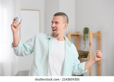 Emotional Man Holding Wireless Portable Speaker And Dancing In Room