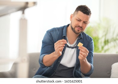 Emotional Man With Nicotine Patch And Cigarette At Home