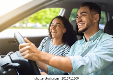 Emotional middle-eastern couple beautiful curly brunette woman and bearded guy travelling by automobile together, looking outdoors and smiling, having sightseeing, enjoying car trip, sun flare - Powered by Shutterstock