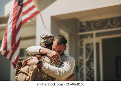 Emotional military homecoming. Female soldier embracing her husband after returning home from the army. American servicewoman reuniting with her husband after serving her country in the military. - Powered by Shutterstock