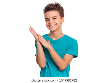 Emotional portrait of caucasian smiling teen boy clapping hands. Happy child joyfully, isolated white background. Handsome funny teenager giving applause.