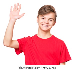 Emotional Portrait Of Caucasian Smiling Teen Boy Wearing Red T-shirt, Stretching His Right Hand Up For Greeting. Happy Child Waving Hand, Isolated White Background. 