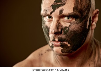 Emotional Portrait Of Fighter. War Paint On His Face And Body